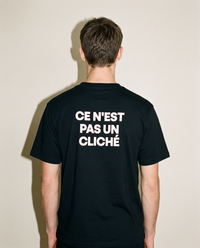 Black heavyweight cotton oversized T-shirt with large 'Ce Nest Pas Un Cliche' graphic slogan printed on both on the front and the back, oversized structured box fit. unisex silhouette and premium streetwear styling.