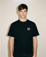 Black heavyweight cotton oversized T-shirt with large 'Ce Nest Pas Un Cliche' graphic slogan printed on both on the front and the back, oversized structured box fit. unisex silhouette and premium streetwear styling.