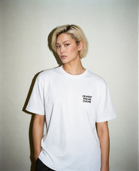 White heavyweight cotton oversized T-shirt with large 'Ce N'ést Pas Un Cliche' graphic slogan printed on both on the front and the back, oversized structured box fit. unisex silhouette and premium streetwear styling.
