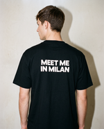 Black heavyweight cotton oversized T-shirt with large 'Meet Me In Milan' graphic slogan printed on both on the front and the back, oversized structured box fit. unisex silhouette and premium streetwear styling.