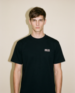 Black heavyweight cotton oversized T-shirt with large 'Meet Me In Milan' graphic slogan printed on both on the front and the back, oversized structured box fit. unisex silhouette and premium streetwear styling.