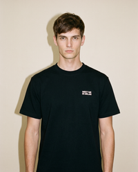 Black heavyweight cotton oversized T-shirt with large 'Meet Me In Milan' graphic slogan printed on both on the front and the back, oversized structured box fit. unisex silhouette and premium streetwear styling.