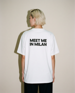 White heavyweight cotton oversized T-shirt with large 'Meet Me In Milan' graphic slogan printed on both on the front and the back, oversized structured box fit. unisex silhouette and premium streetwear styling.