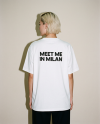 White heavyweight cotton oversized T-shirt with large 'Meet Me In Milan' graphic slogan printed on both on the front and the back, oversized structured box fit. unisex silhouette and premium streetwear styling.