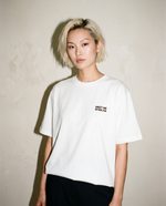 White heavyweight cotton oversized T-shirt with large 'Meet Me In Milan' graphic slogan printed on both on the front and the back, oversized structured box fit. unisex silhouette and premium streetwear styling.
