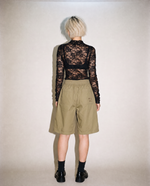 thirdofthefifth pleated breathable cotton shorts in muted earthy tone featuring front pleats, elasticated waistband, relaxed tailored fit, and above-knee silhouette designed for warm-weather dressing. unisex