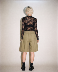 thirdofthefifth pleated breathable cotton shorts in muted earthy tone featuring front pleats, elasticated waistband, relaxed tailored fit, and above-knee silhouette designed for warm-weather dressing. unisex