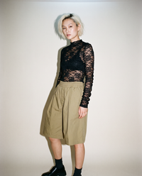 thirdofthefifth pleated breathable cotton shorts in muted earthy tone featuring front pleats, elasticated waistband, relaxed tailored fit, and above-knee silhouette designed for warm-weather dressing. unisex
